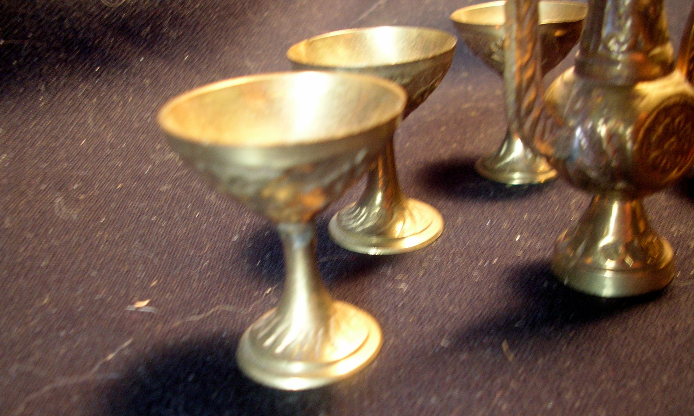 This is 4 brass cups and a brass coffee or tea pot. cups measure 3/4